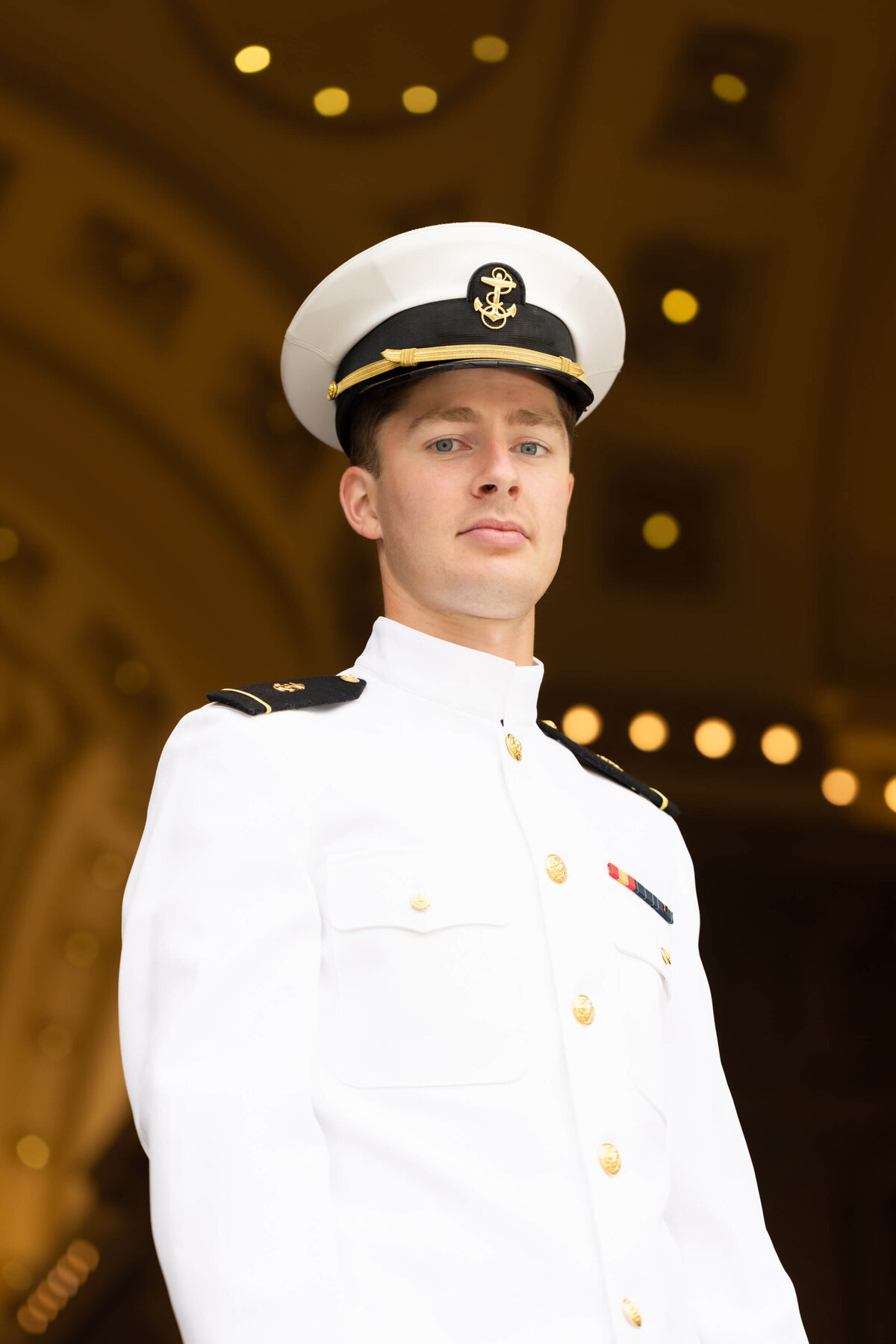 Navy officer in white uniform at Bancroft Hall in Annapolis, Maryland.