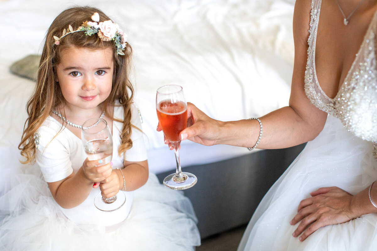 Young flower girl toasting with juice