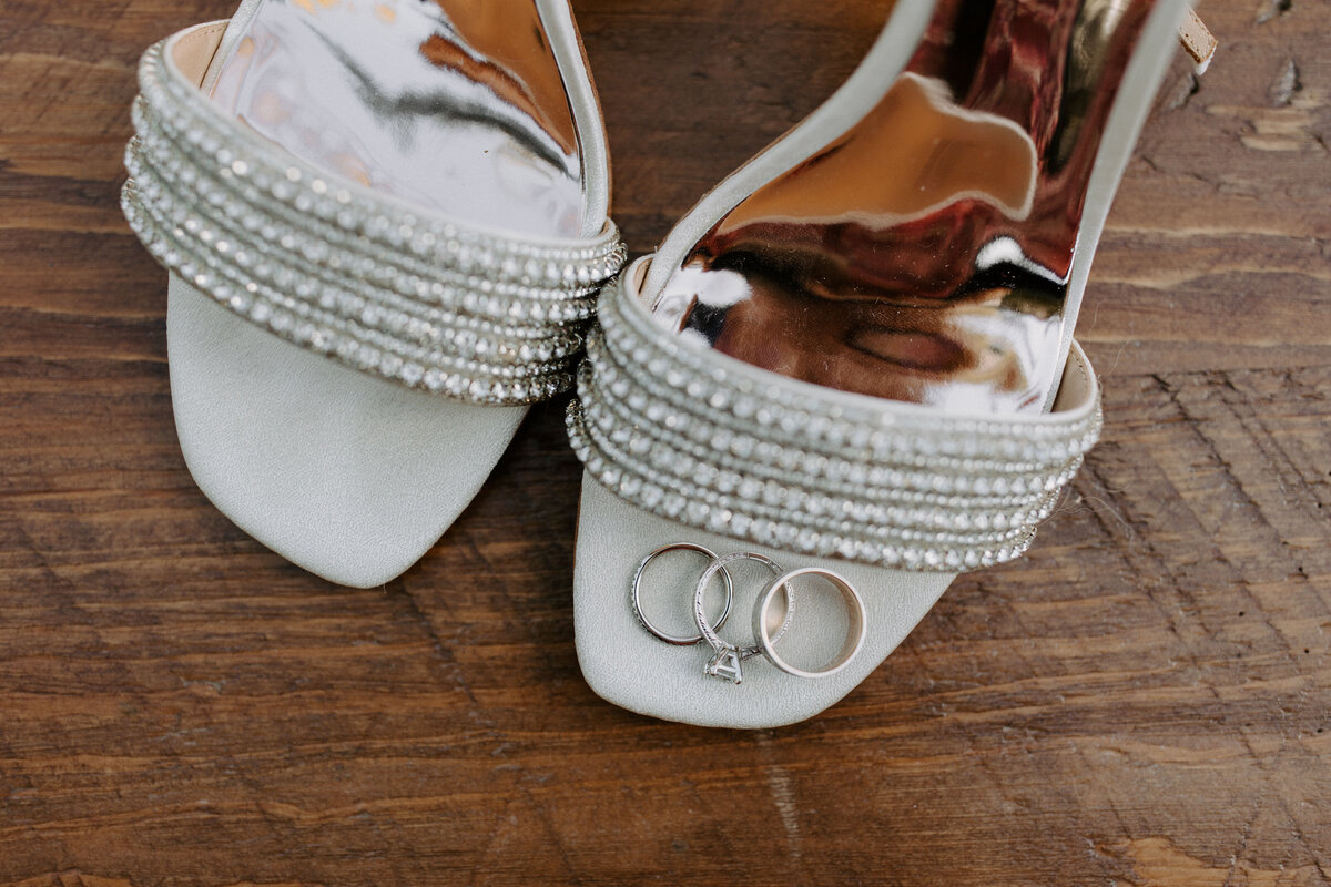 white heels with 3 rings laid on top of one of them