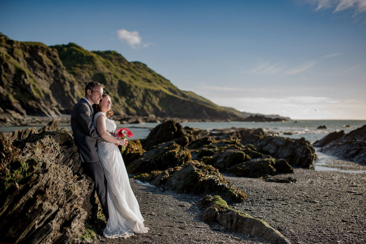 Bride and Groom on the rocks at Tunnels Beaches Devon
