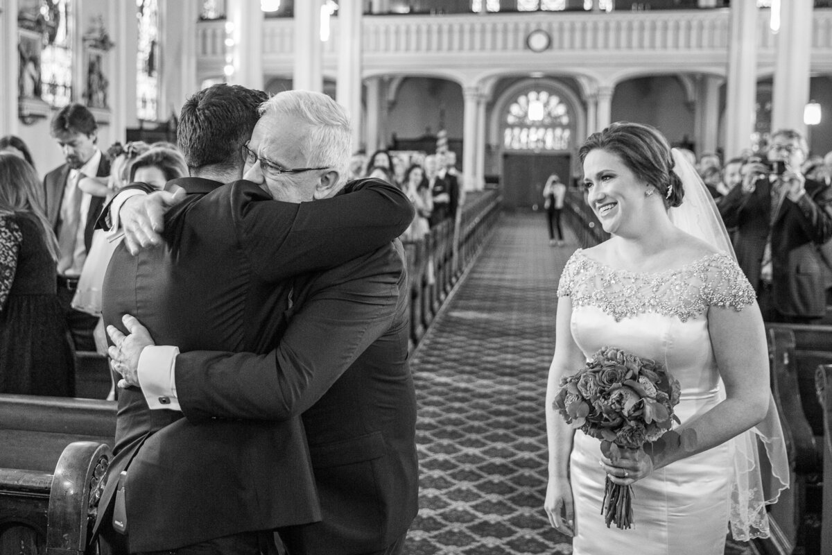 A father gives her daughter away at a wedding reception in St. Michael’s church in Chicago.