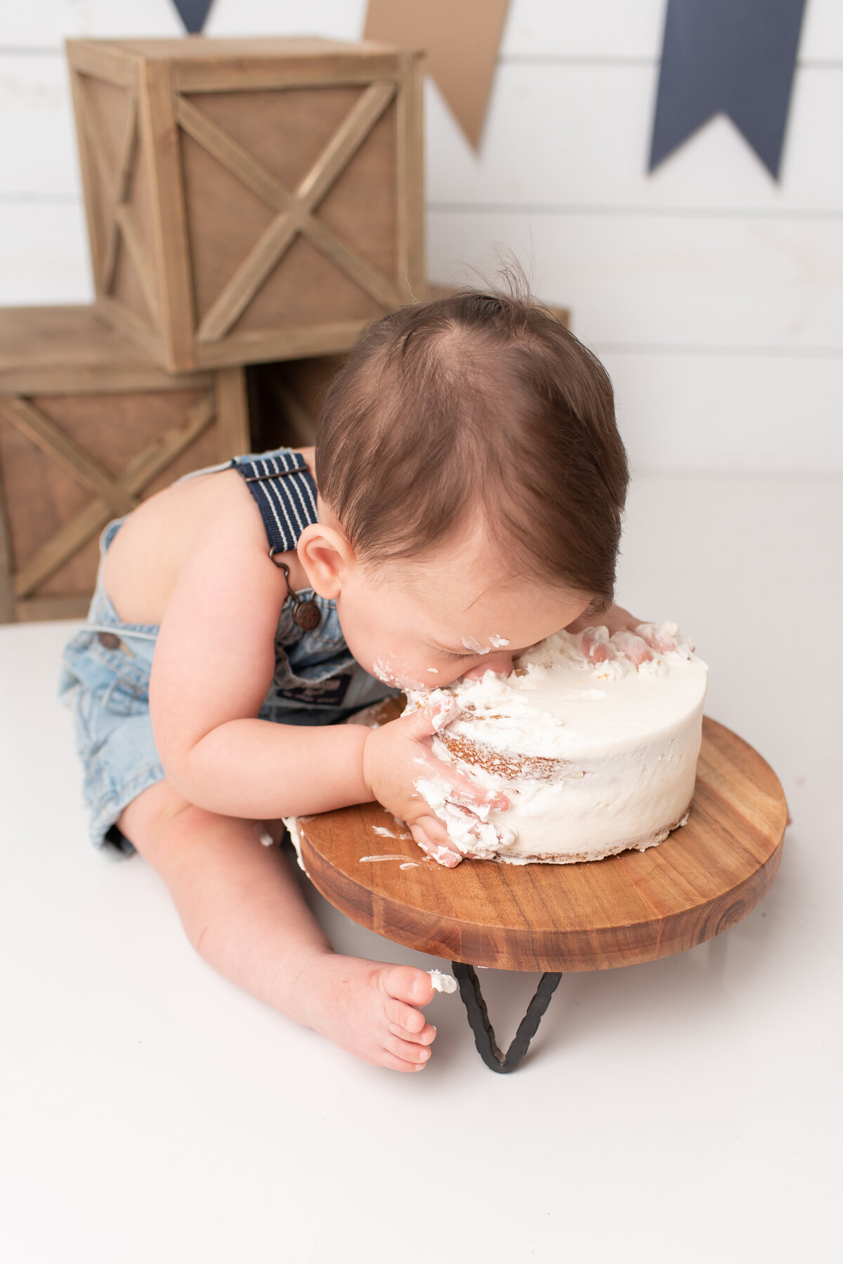 Baby face planting in cake
