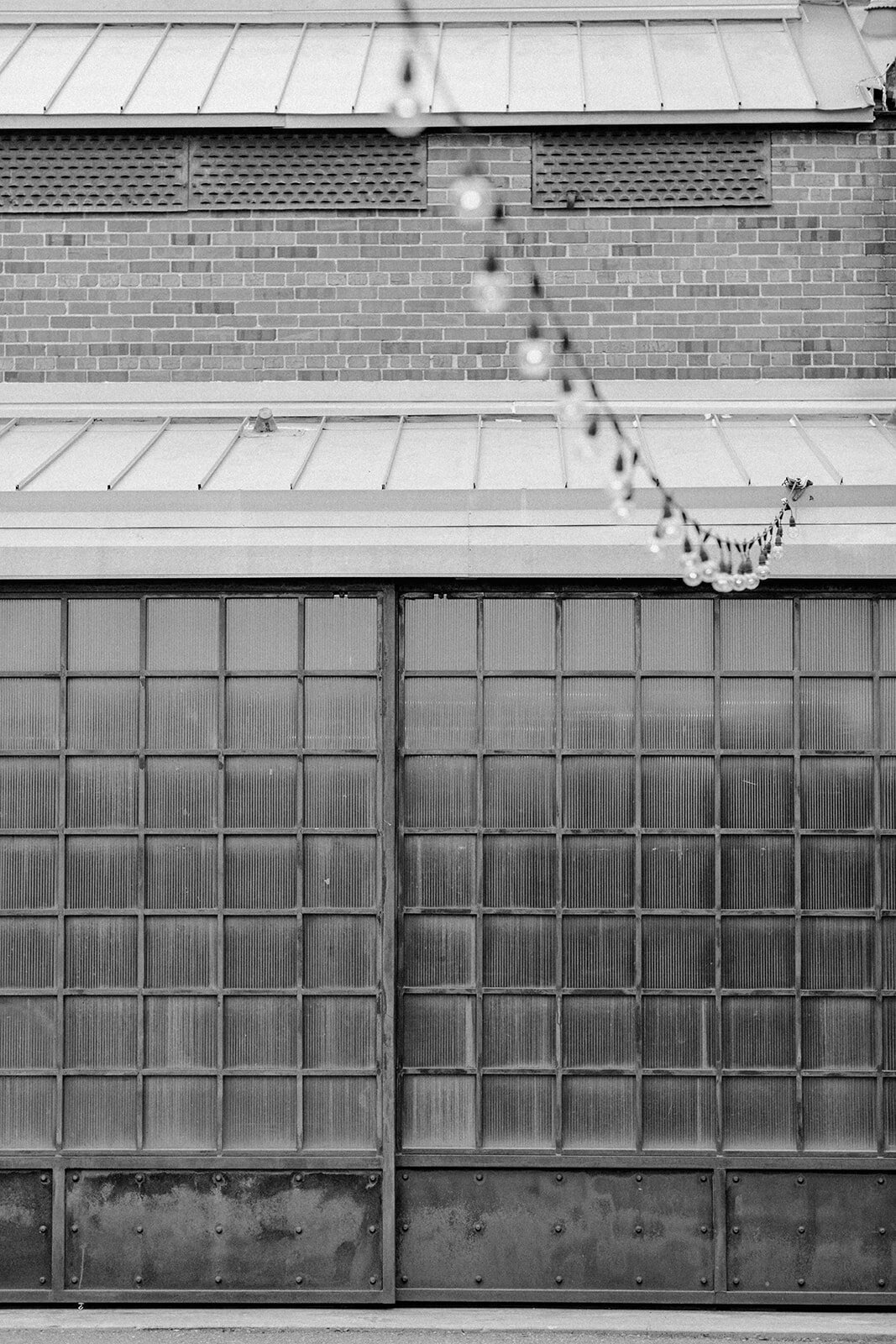 A black and white photo of the outside of a website copywriter's office building with string lights