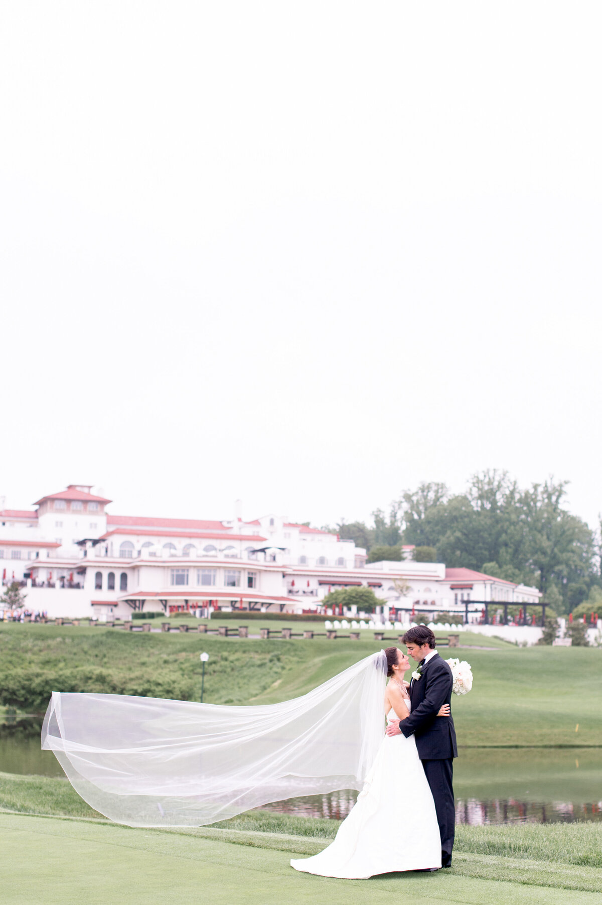 Bride and groom in front of Congressional Country Club  for luxury Washington DC wedding day