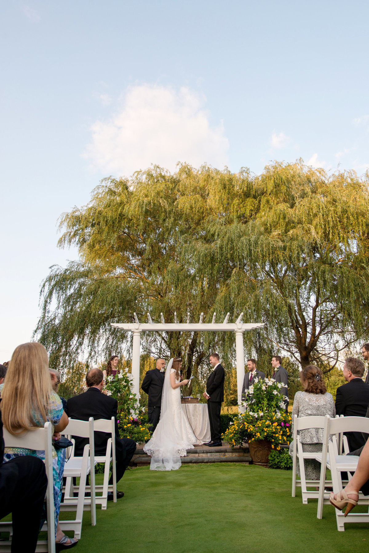 photo of ceremony with bride and groom during wedding at Willow Creek Golf and Country Club