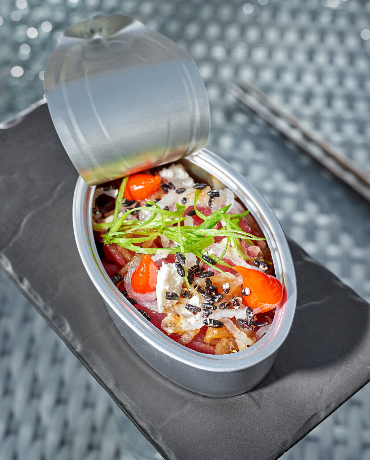 A tin can filled with a colorful dish