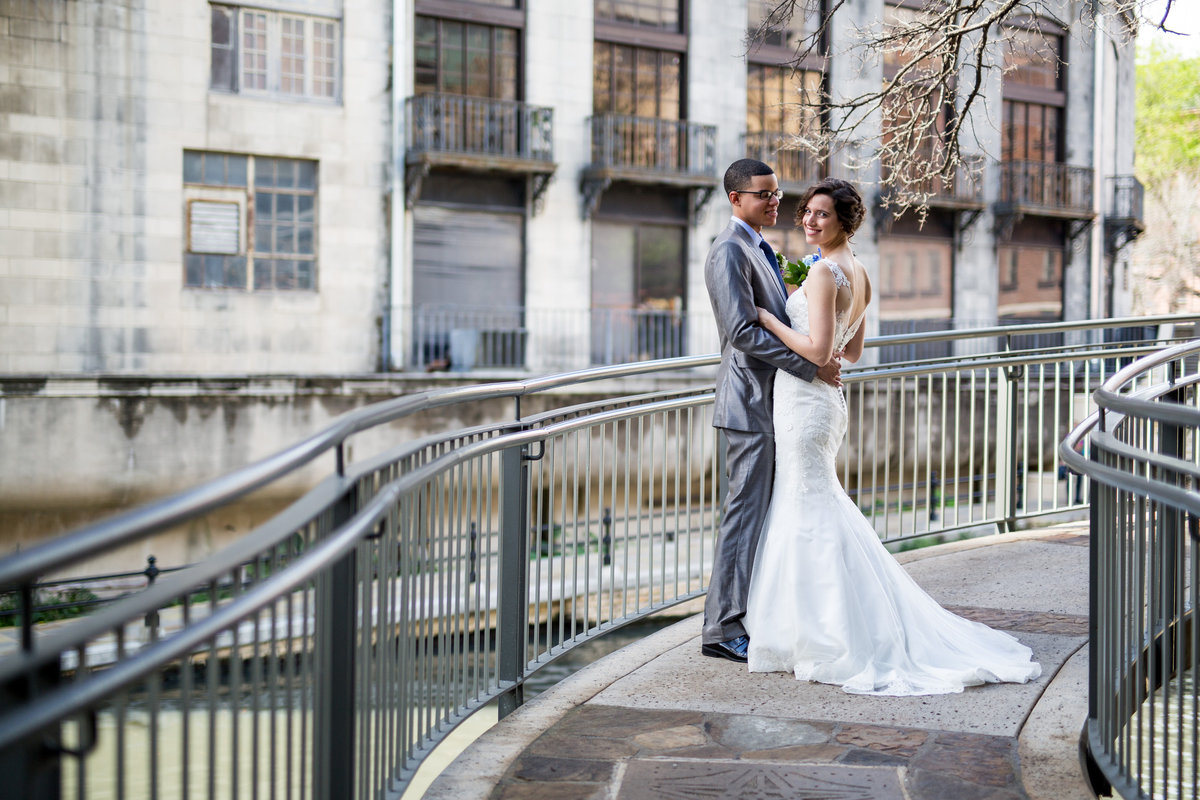 bride and groom on San Antonio River Walk bridge