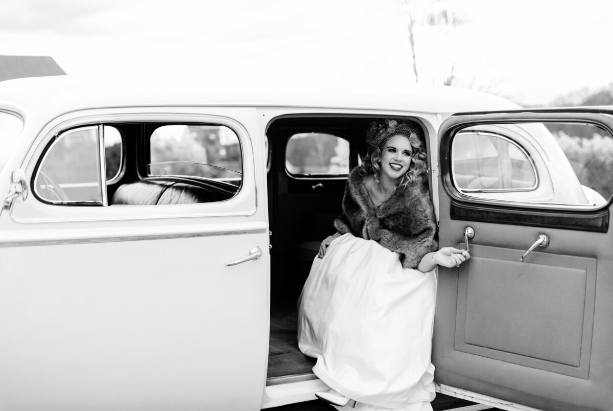 A gorgeous bride in fur coat gets into the getaway car