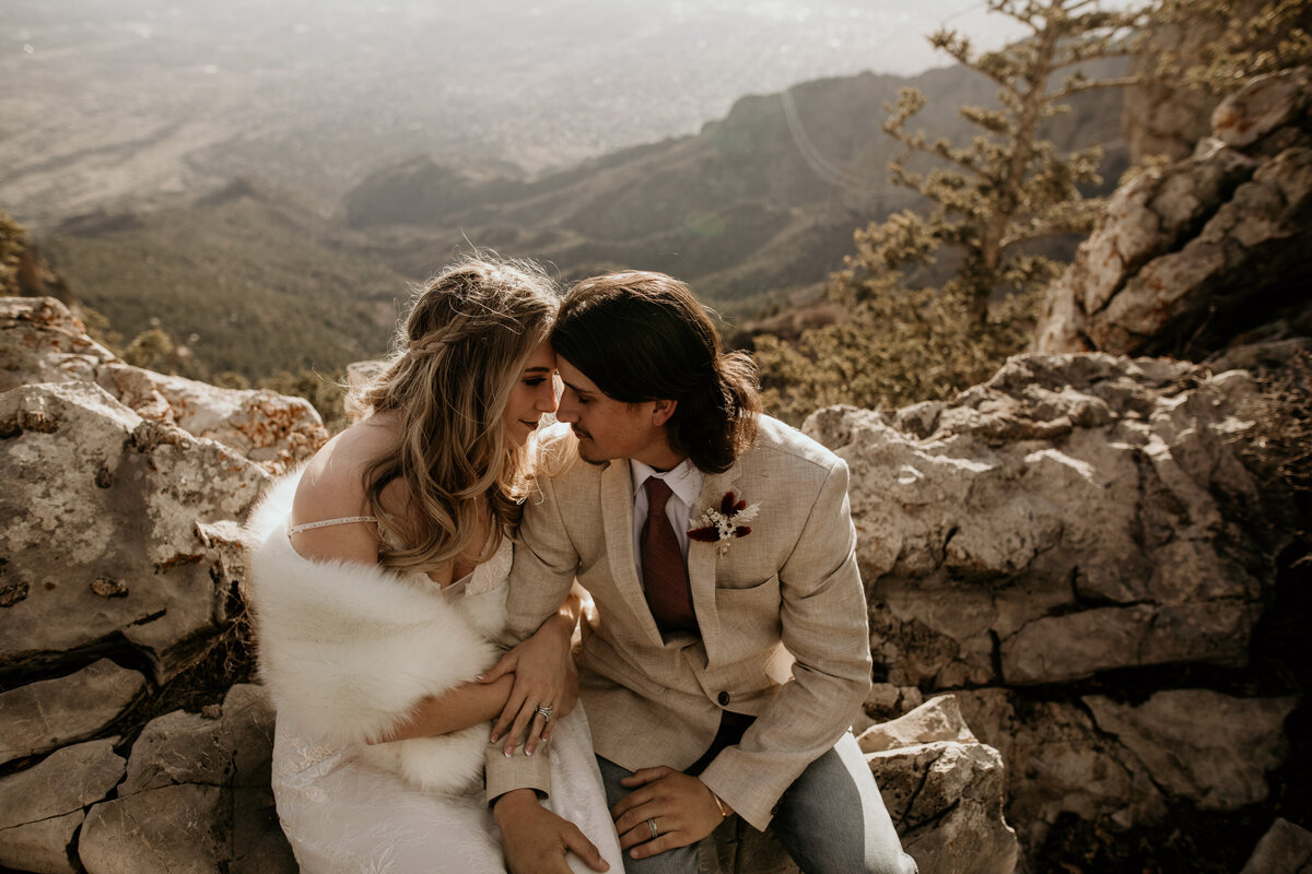 bride and groom sitting together at Sandia Peak in Albuquerque