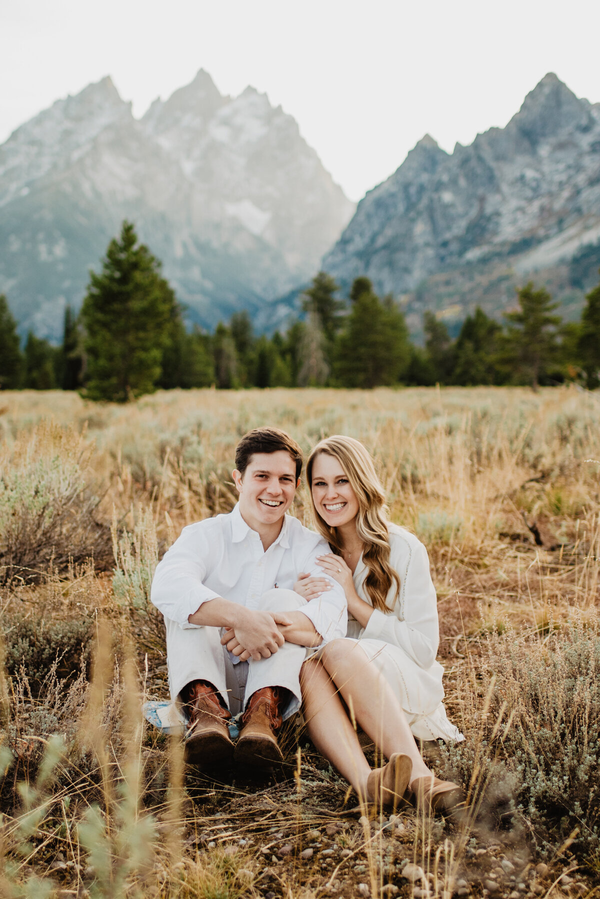 Photographers Jackson Hole capture couple sitting together in grass