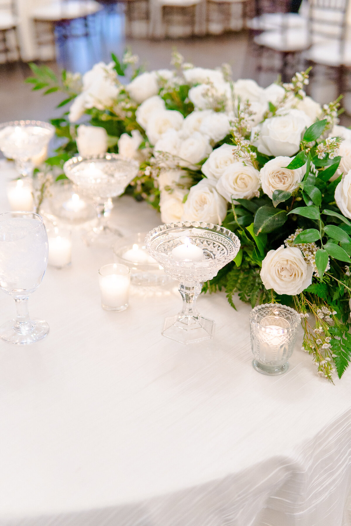 beautiful lush white and greenery sweetheart table arrangement for an austin wedding