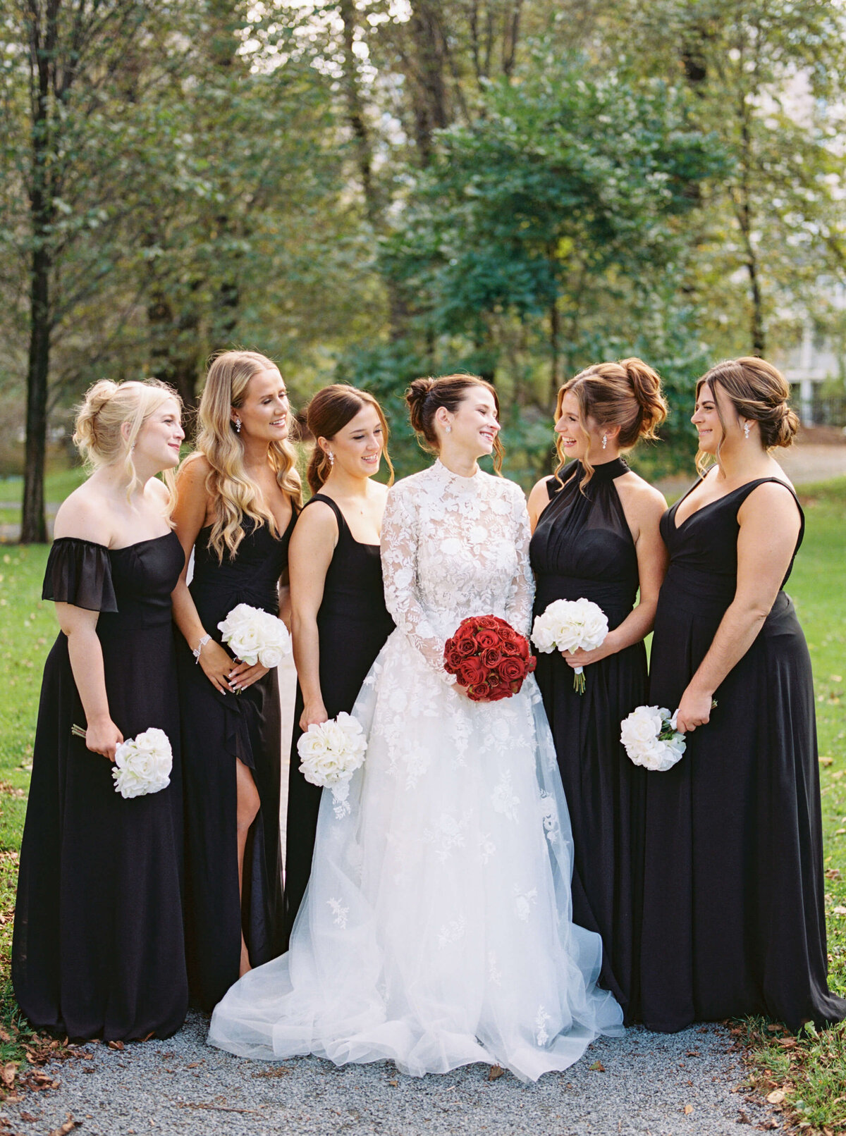 Bride with bridesmaids wearing all black at park in Halifax, Nova Scotia