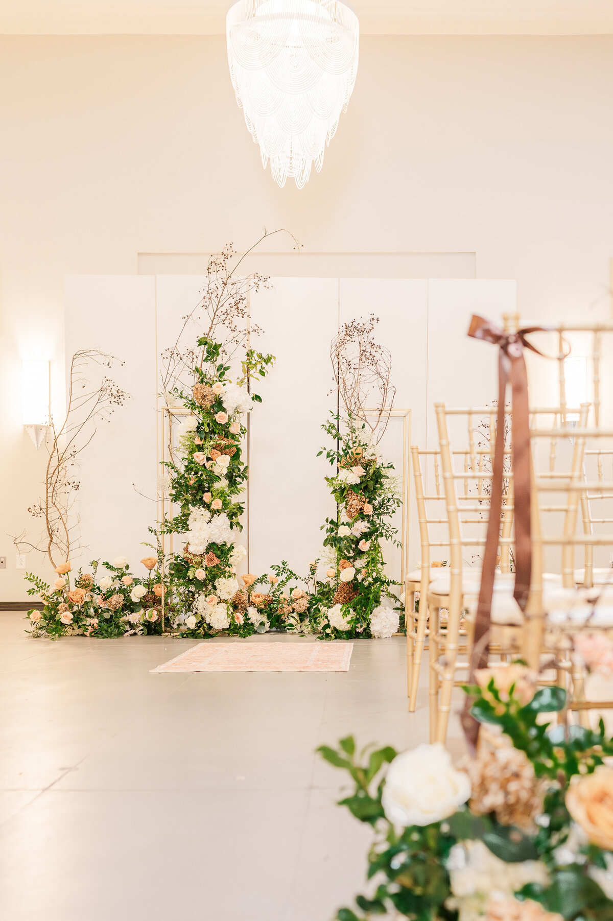 A warm wedding reception at The Orpheum with brown ribbon and pink and blush flowers in greenery in Oxford by JoLynn Photography, a Raleigh wedding photographer