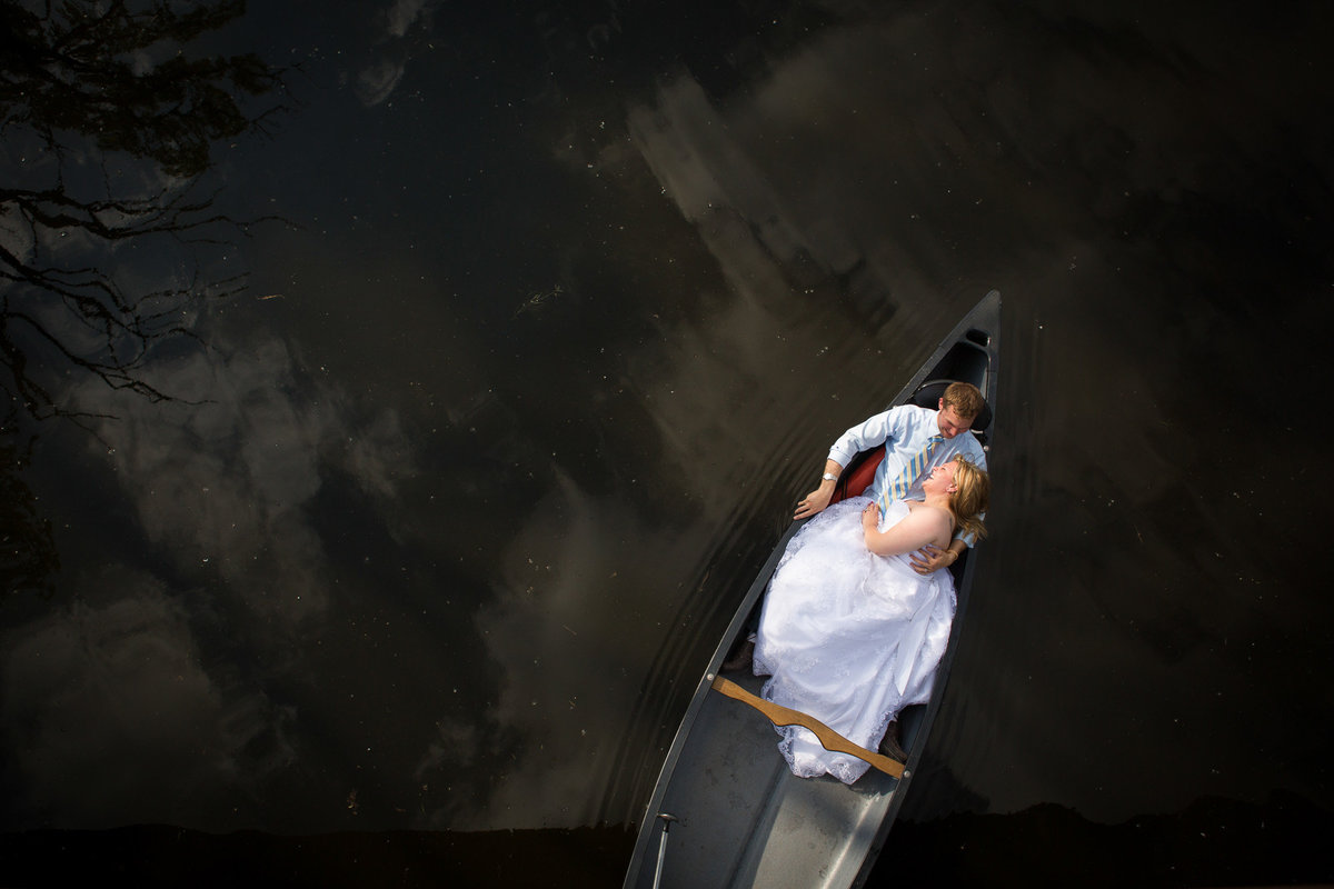 Trash The Dress session on a canoe for a bride and groom