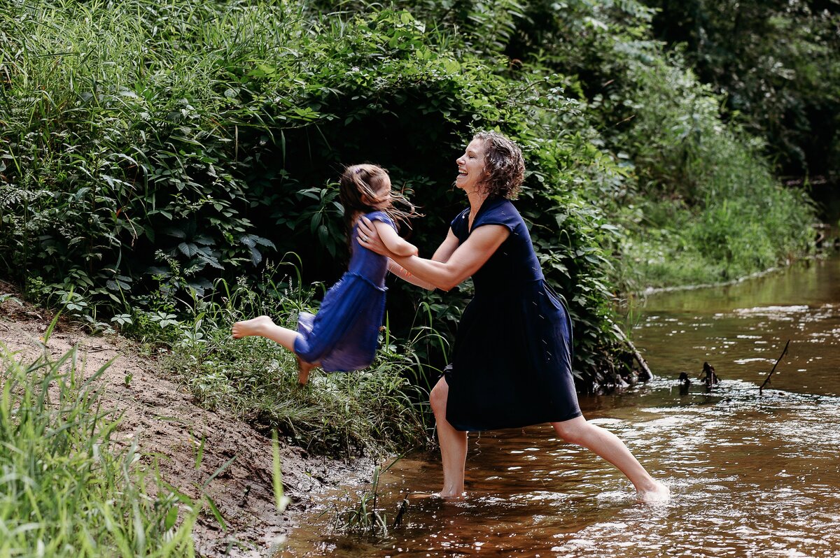 Mother catching child in creek McKennaPattersonPhotography