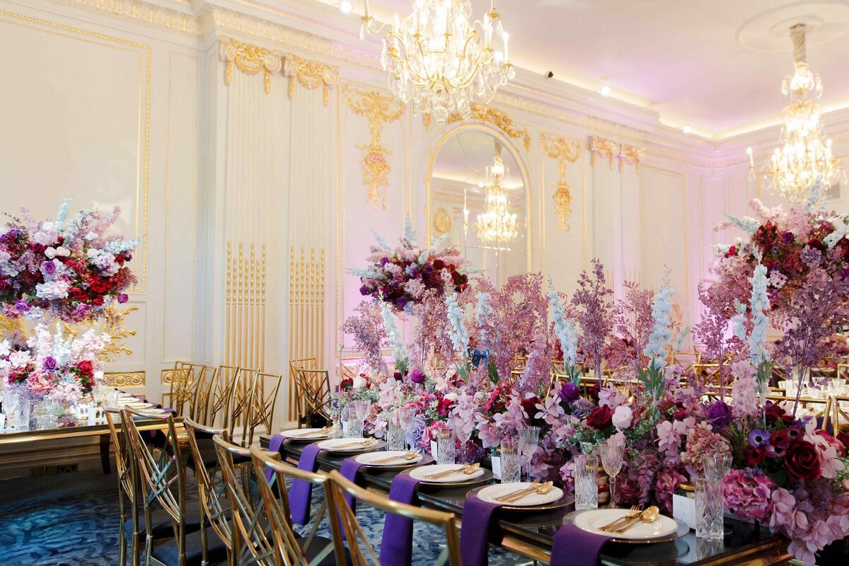 mixed table shapes and vibrant wild florals  in mandarin oriental hyde park london with white and gold ornate detailing on the wall