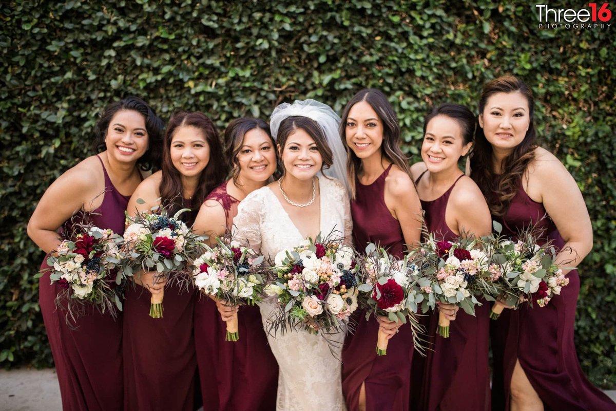 Bride poses with her bridesmaids