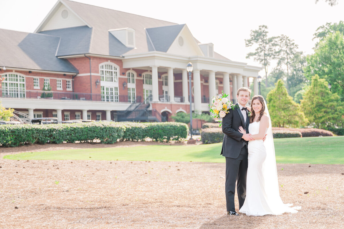 A loving couple embracing during sunset of their summer wedding at the Prestonwood Country Club by destination wedding photographer, JoLynn Photography