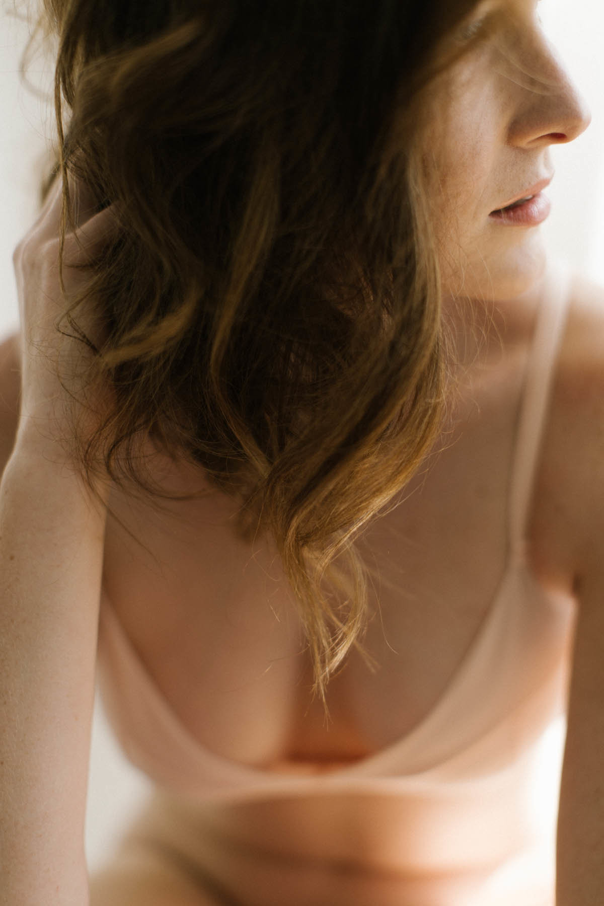 Woman with peach lingerie during boudoir session