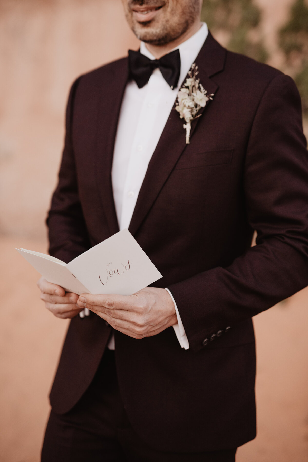 Utah elopement photographer captures groom holding vow book