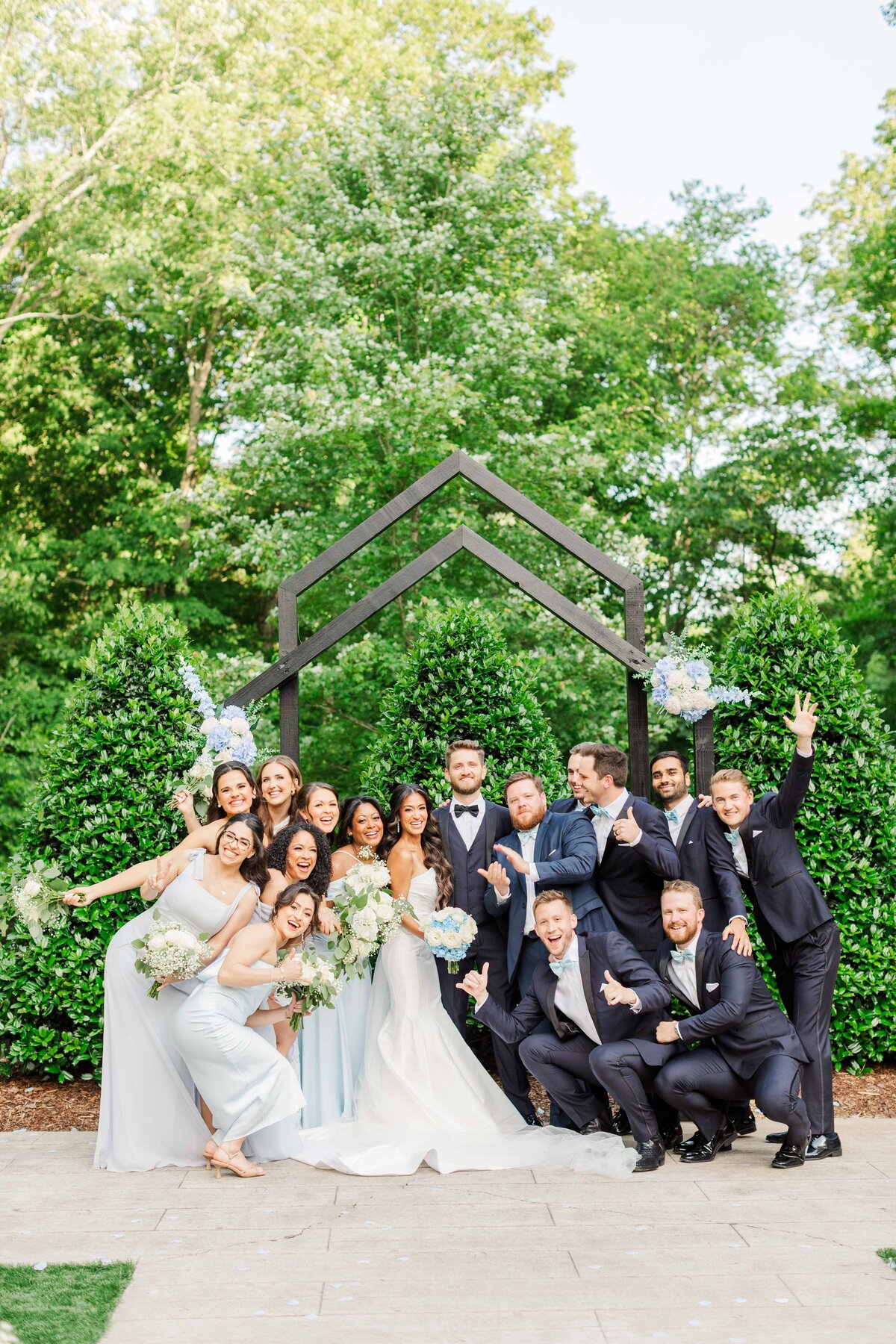 Wedding Party cheering while surrounding bride and groom on their Nashville, TN wedding day at the Barn at Firefly Lane
