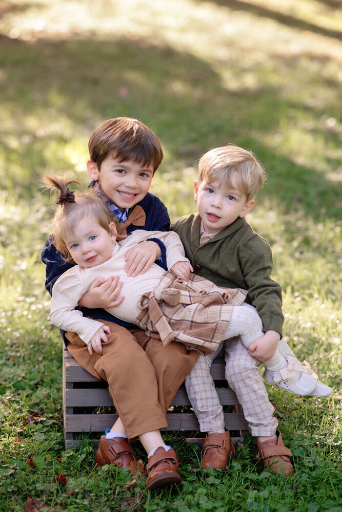 Family session with children sitting on grass