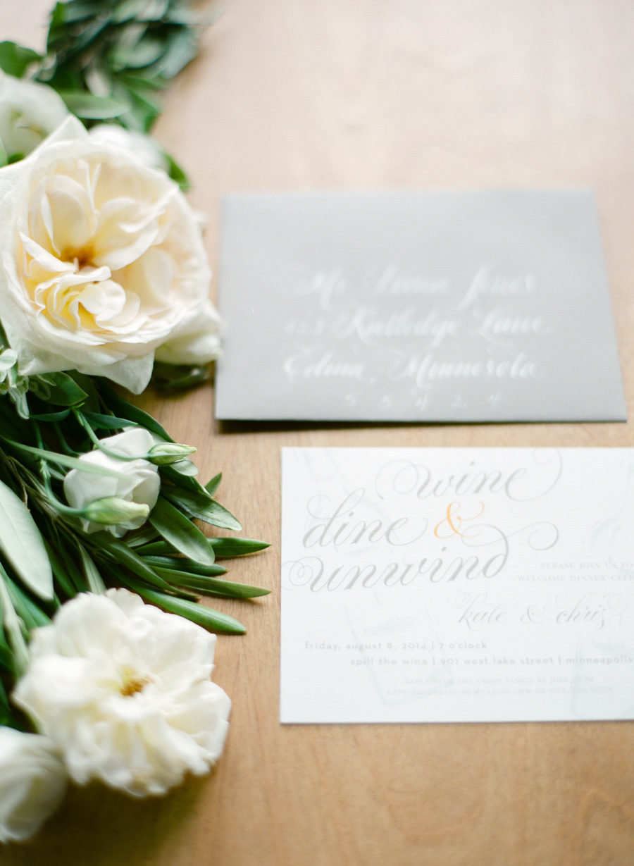 white flowers with wedding invitaions