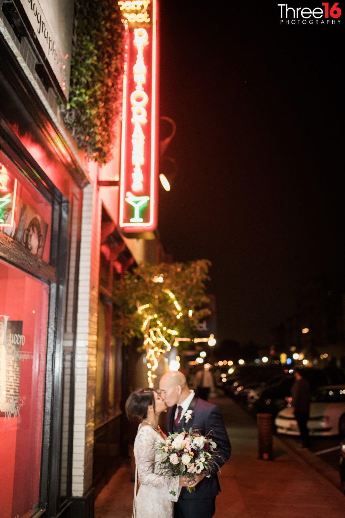 Night time kiss for Bride and Groom outside a downtown Fullerton nightclub