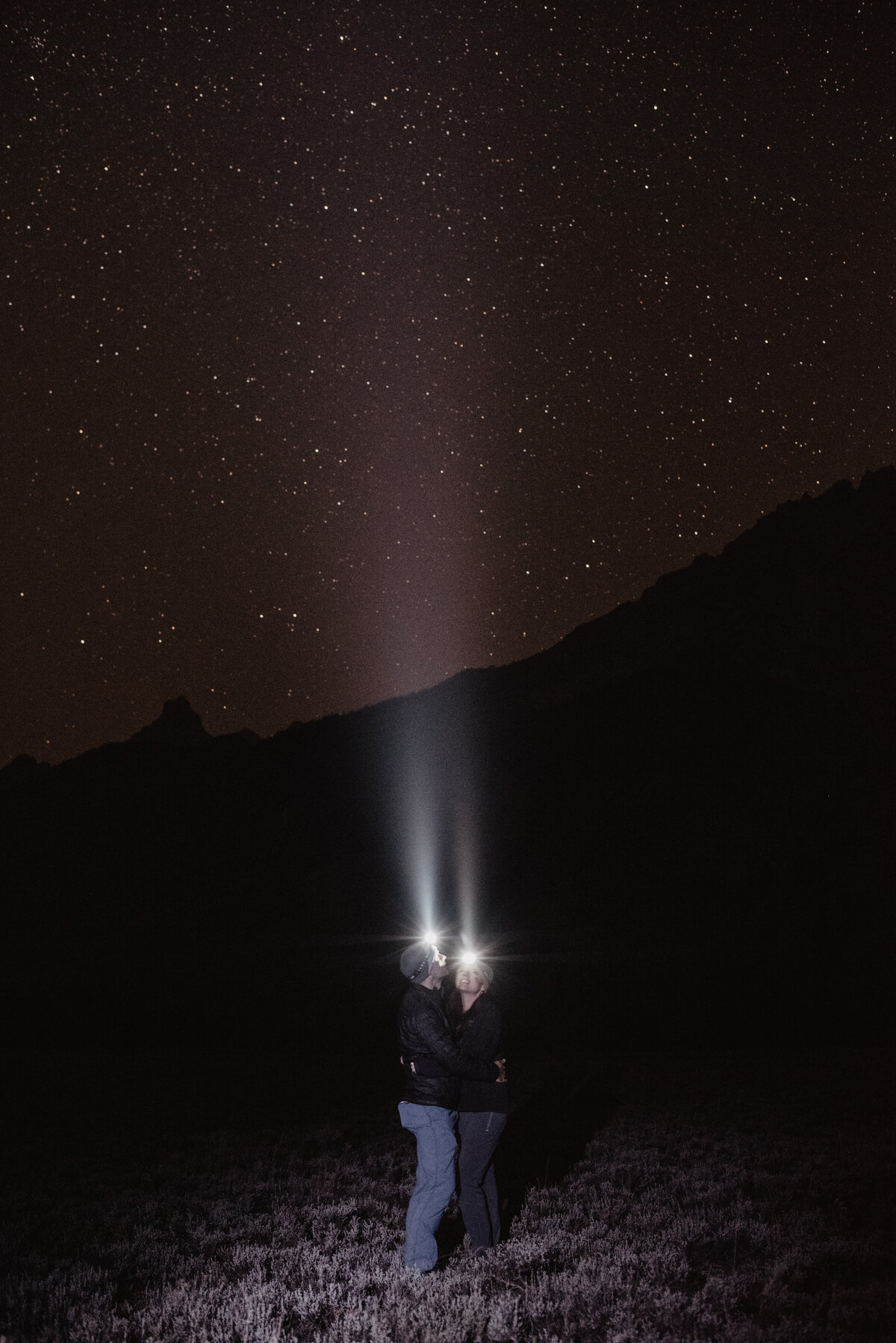 Jackson Hole Photographers capture couple kissing with headlights on