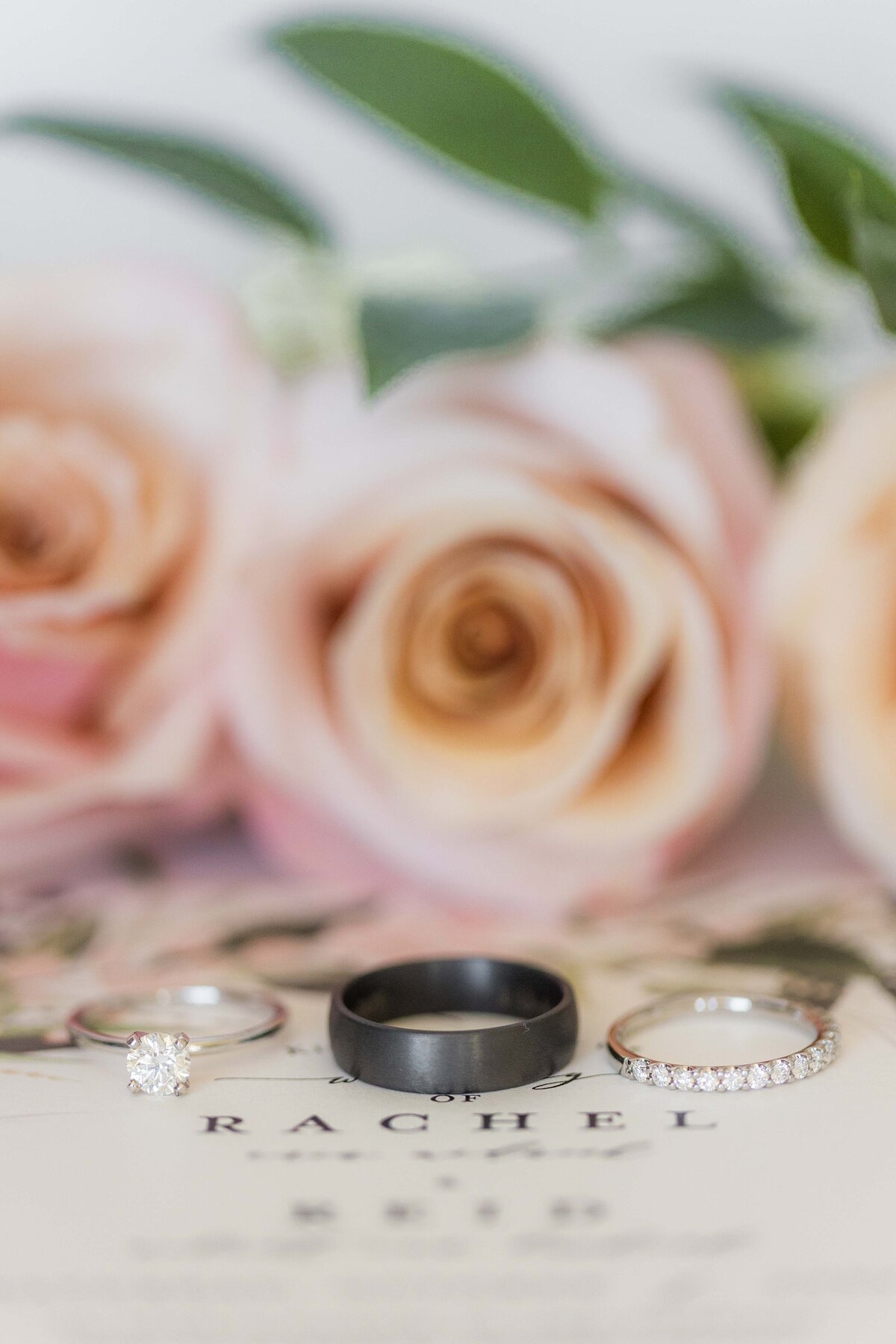 wedding-rings-on-invitation-pink-flowers