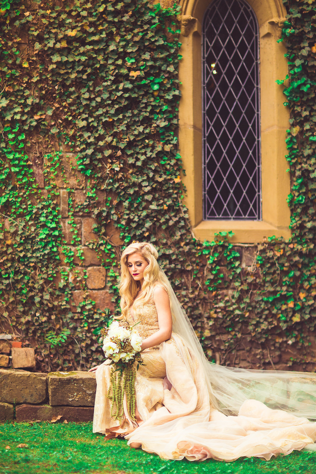 Wedding Photograph Of Bride Looking at Her Bouquet and  Sitting Beside a Window Los Angeles