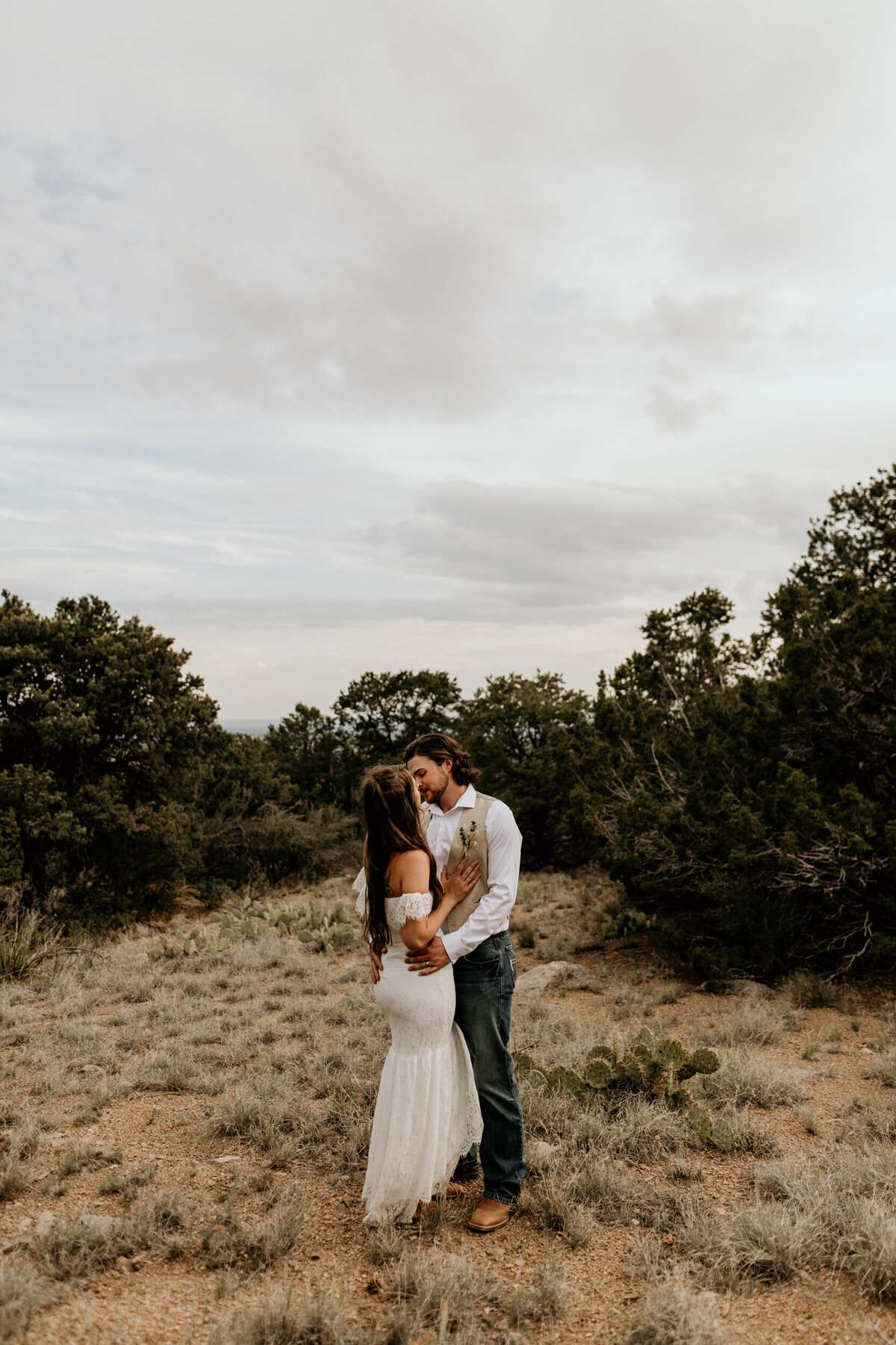 Bride and groom holding each other at the foothills in Albuquerque New Mexico
