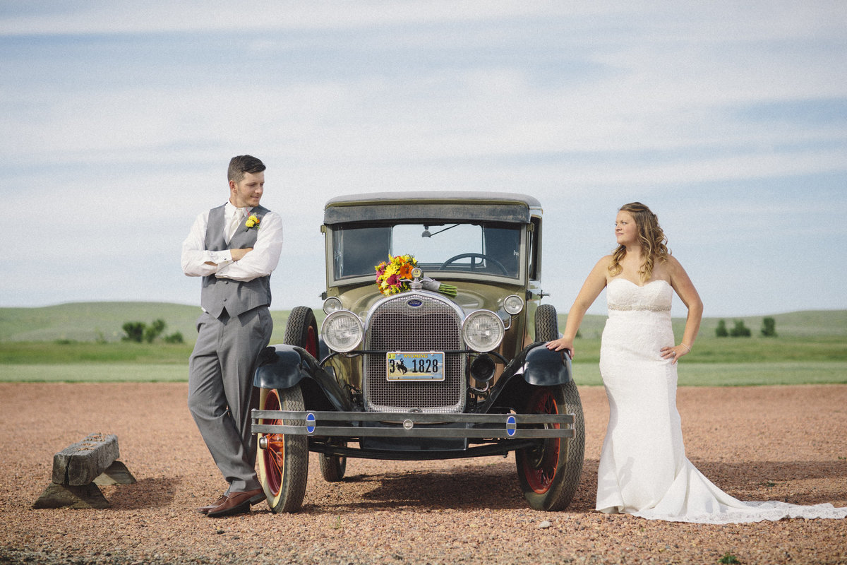 Bride and Groom Pose by Old Collector Car