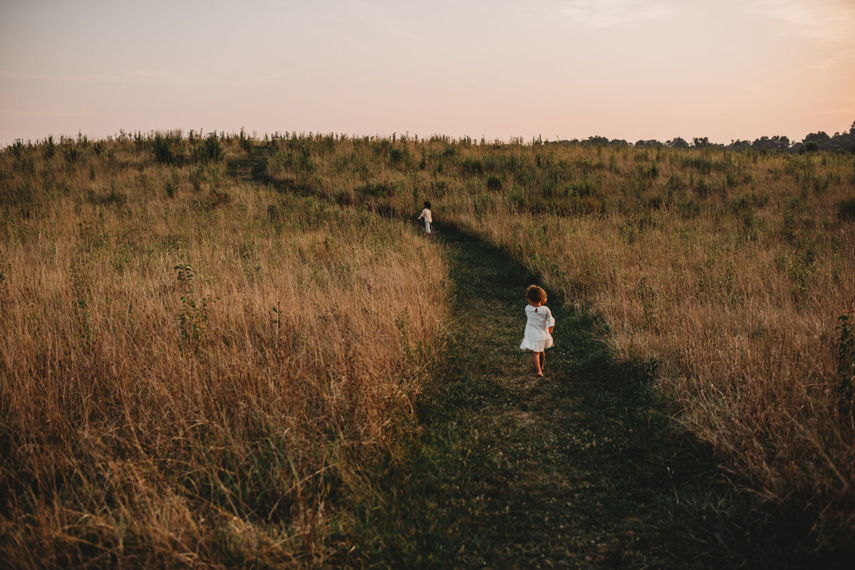 Kids running through field at Howard County Conservancy captured by Ellicott City Family Photographer