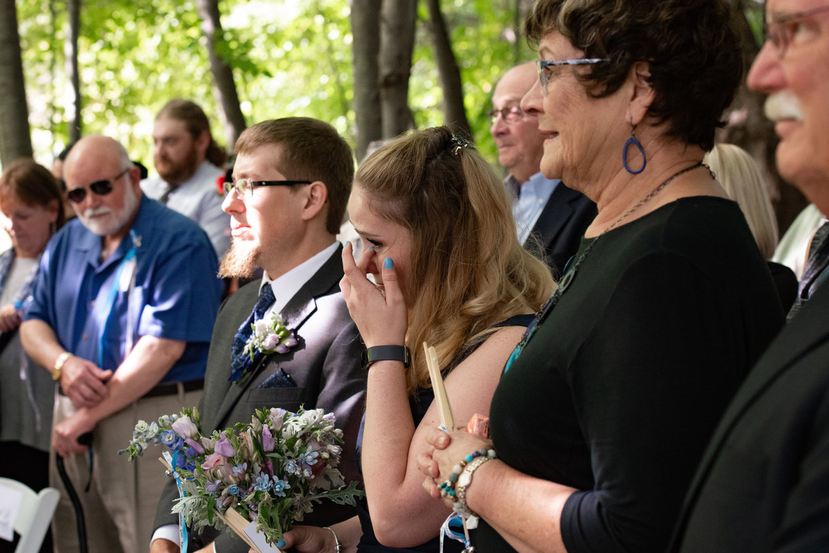 guest cries at ceremony wipes tear