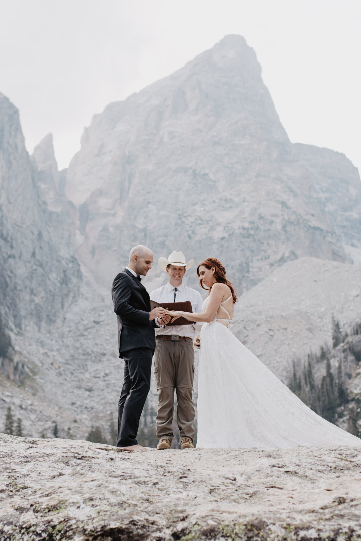 Jackson Hole photographers capture bride and groom praying together