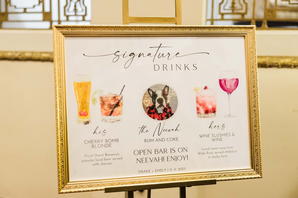 A sign at a park farm winery wedding displays "signature drinks" with illustrations and descriptions of four beverages, labeled "his, hers, the newark, and hers," for guests to enjoy.