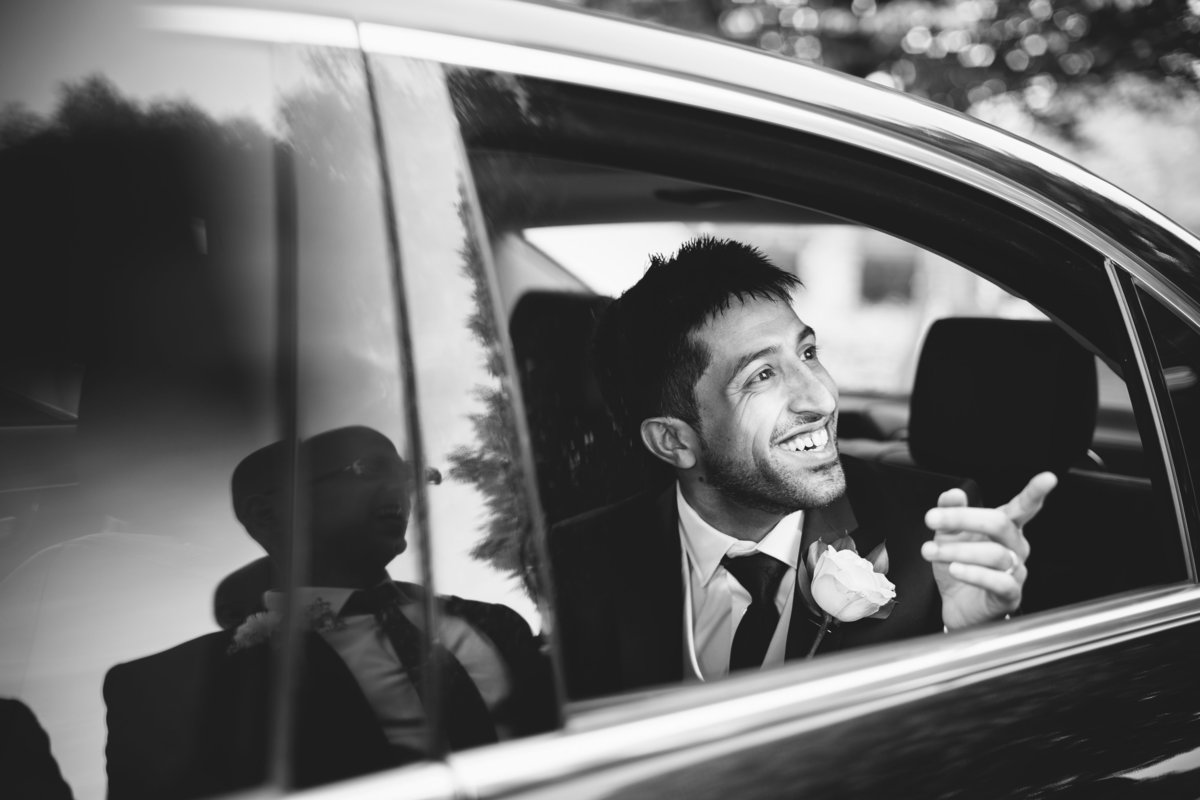 groom in car pointing finger