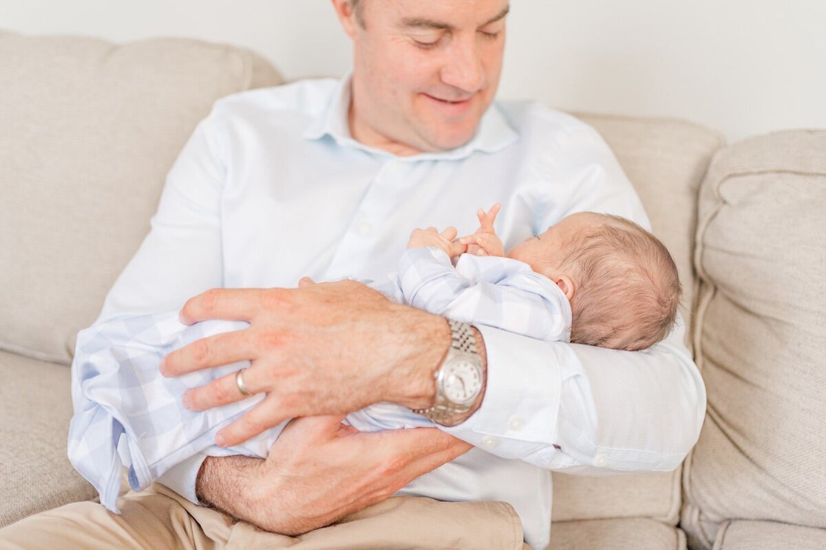 dad holding baby during lifestyle newborn photos in Northern VA