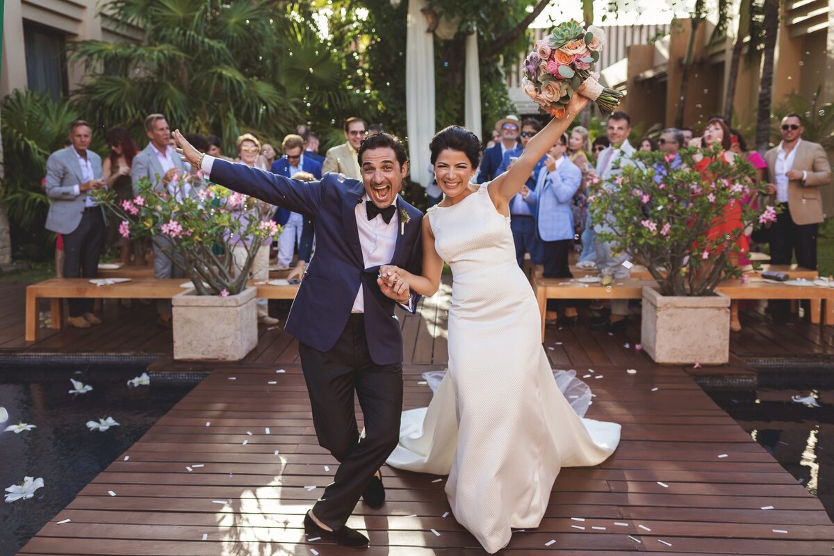 Bride and groom celebrate after wedding in Riviera Maya