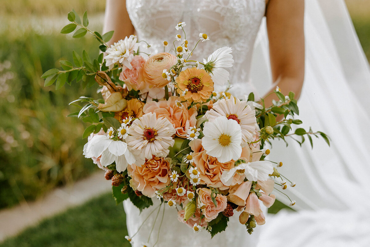 Summer peach, white and blush bridal bouquet with cosmos, zinnias and roses
