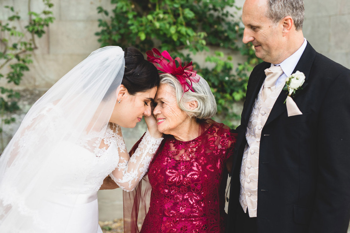 Natural wedding photograph of a bride embracing her grandma