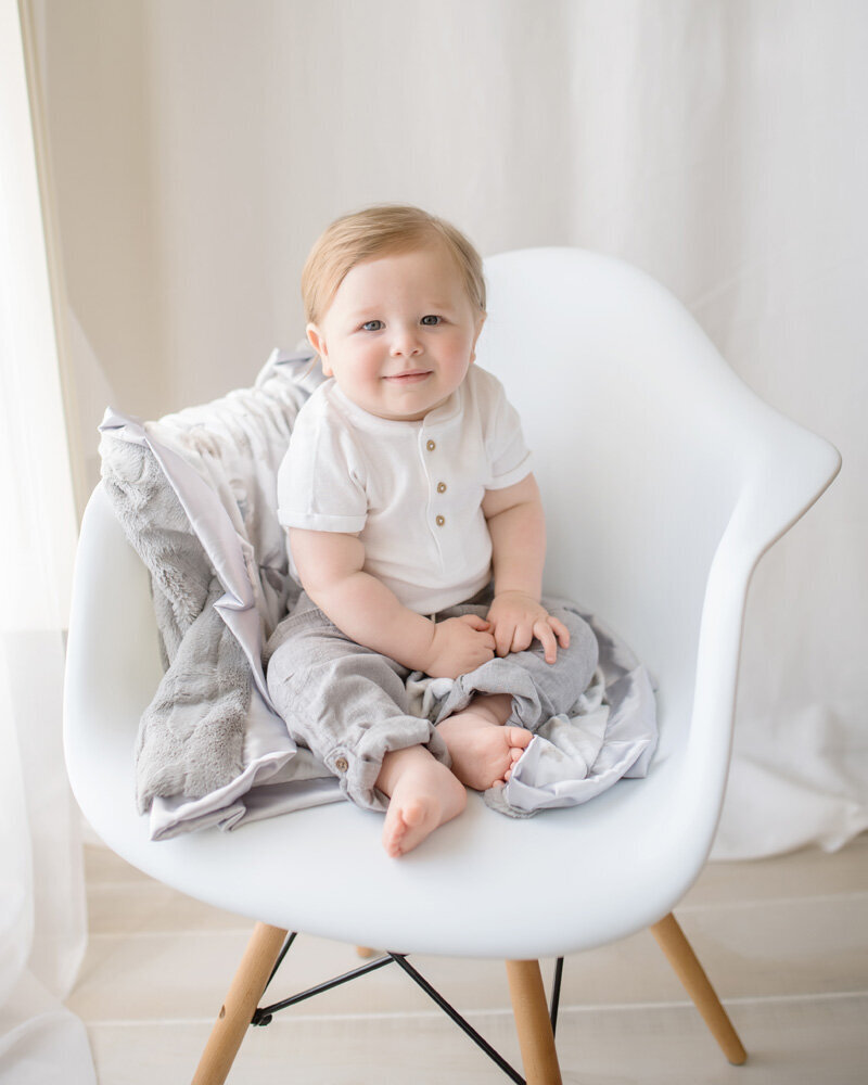 Family session of little boy sitting on a chair