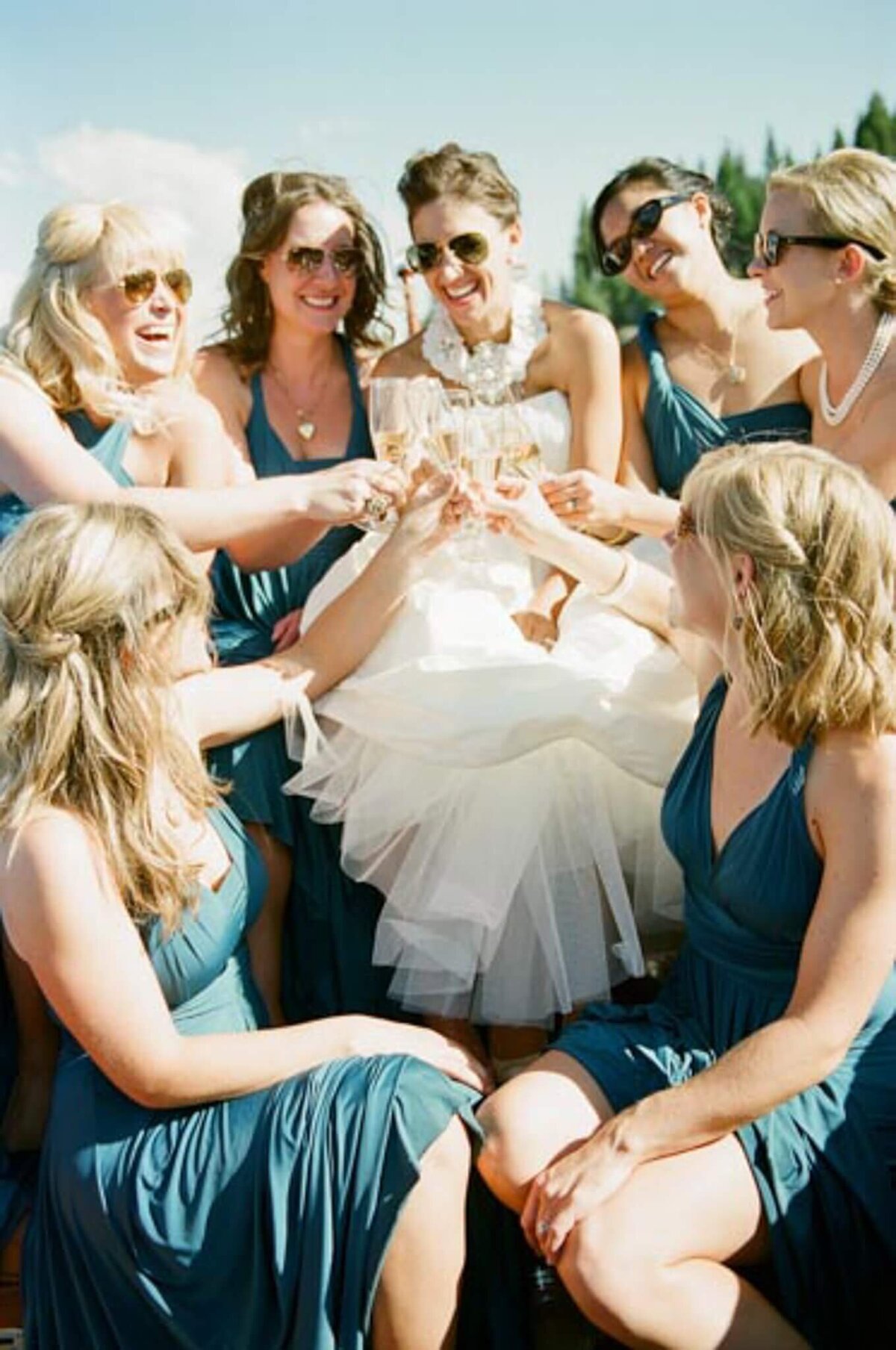 color film image of bride champagne toasting with her maids