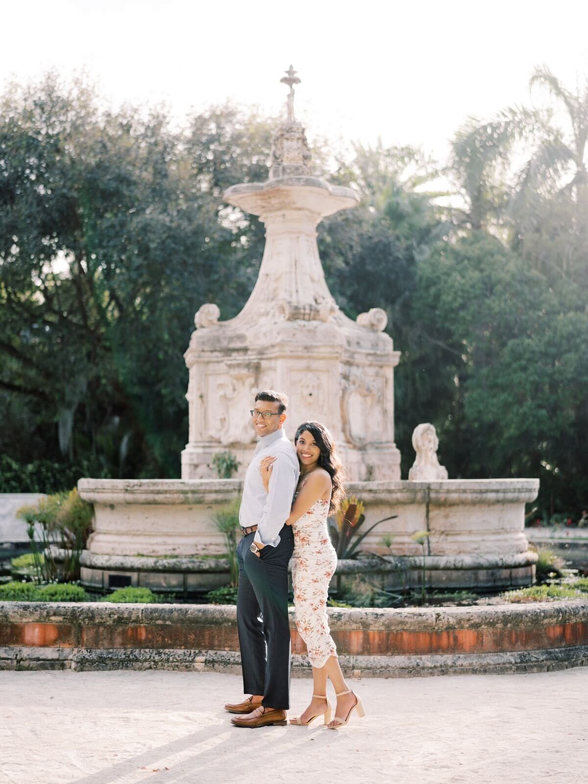 Couple-standing-in-the-gardens-at-Vizcaya-Museum-at-their-engagement-session-with-chicago-wedding-photographer