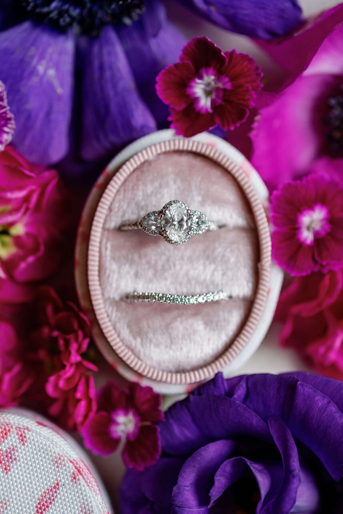 Wedding rings surrounded by colorful florals