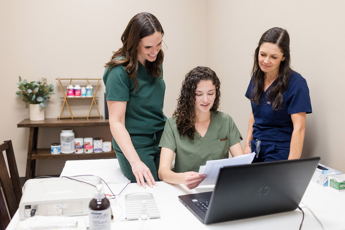 The Eau Claire Acupuncture team looking at lab results