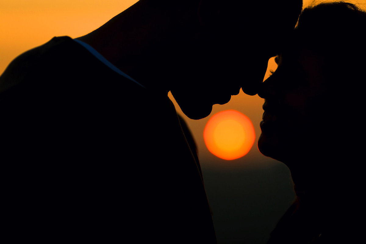A silhouette of a couple on their pre wedding photo shoot at sunset