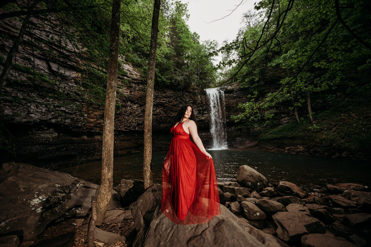 photo of a girl in front of a waterfall