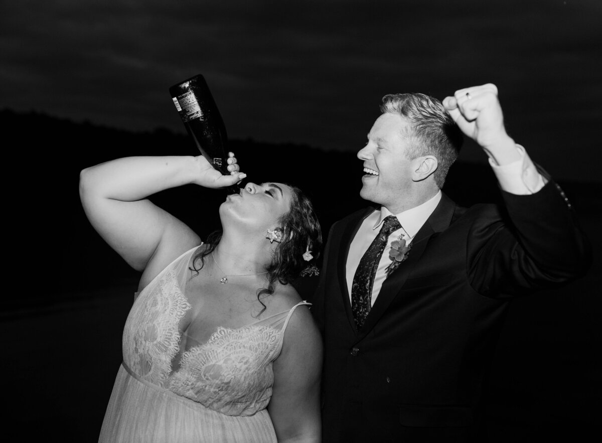 bride drinking champagne, groom cheering on